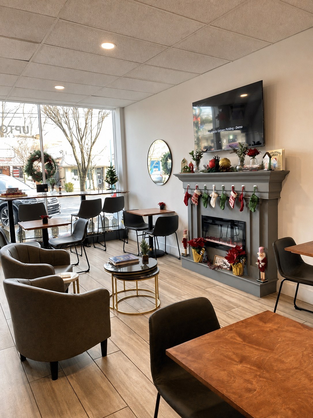 The fireplace lounge corner with armchairs, wood tables, and seasonal decorations